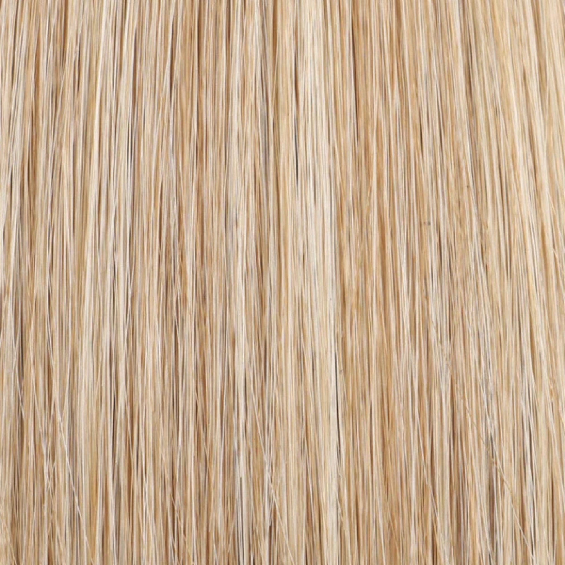 Close-up of blonde hair extensions with a neutral background